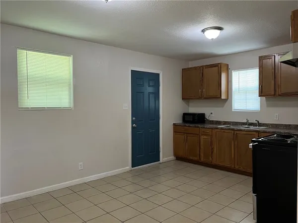 a kitchen with granite countertop a sink and cabinets