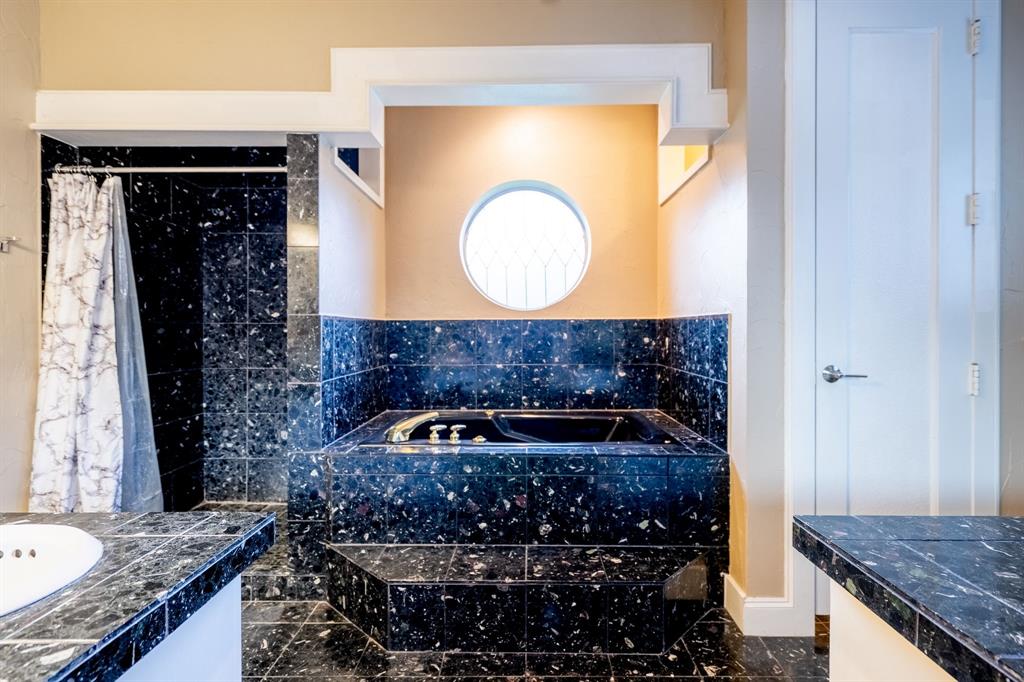 1450 Meandering Way Rockwall, TX 75087 - Photo 19 of 32 a bathroom with a granite countertop sink and mirror