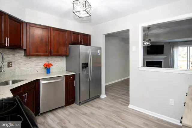 a kitchen with stainless steel appliances granite countertop a stove and cabinets