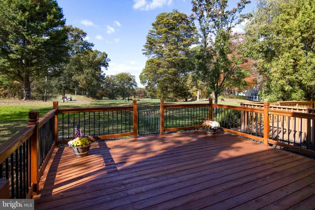 a view of backyard with deck and wooden floor