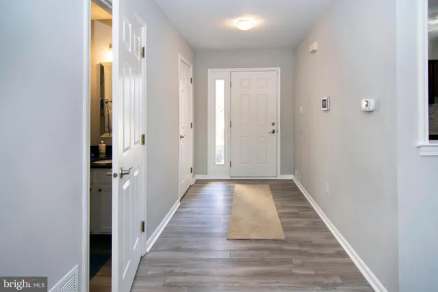a view of a living room with furniture and wooden floor