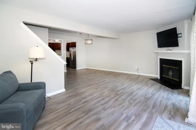 wooden floor in an empty room with a fireplace