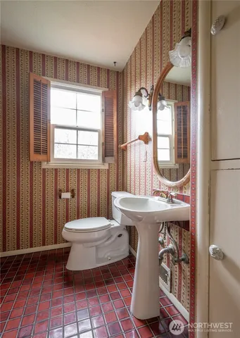 a bathroom with a sink toilet mirror and tub