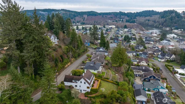 an aerial view of a house with a garden and lake view