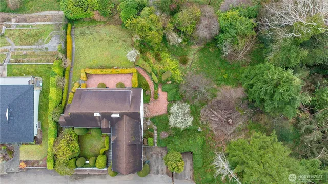 an aerial view of a house with garden space and street view