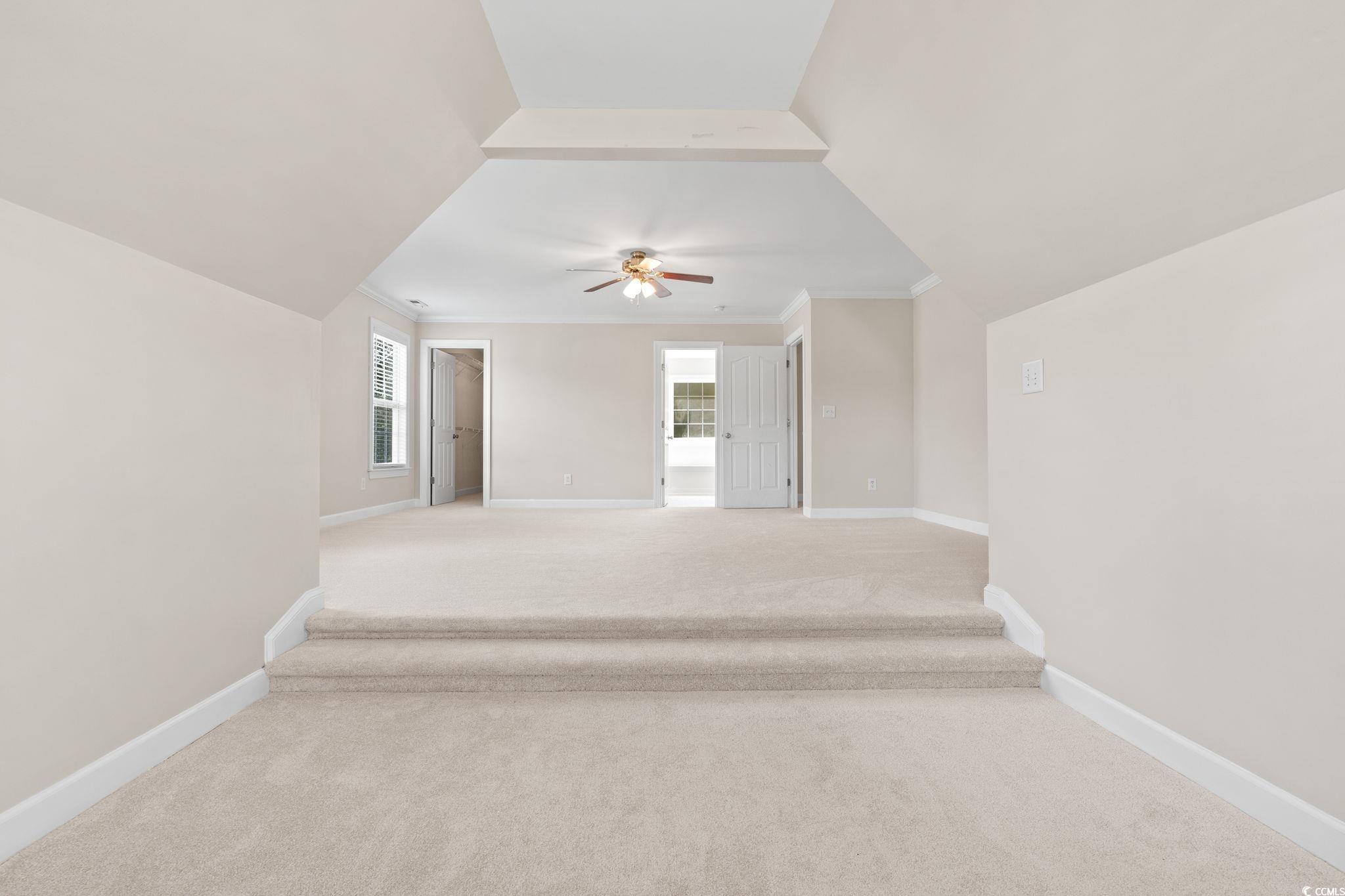 181 Dunbarton Lane Conway, SC 29526 - Photo 21 of 40 Spare room featuring light colored carpet, ornamental molding, plenty of natural light, ceiling fan, and lofted ceiling