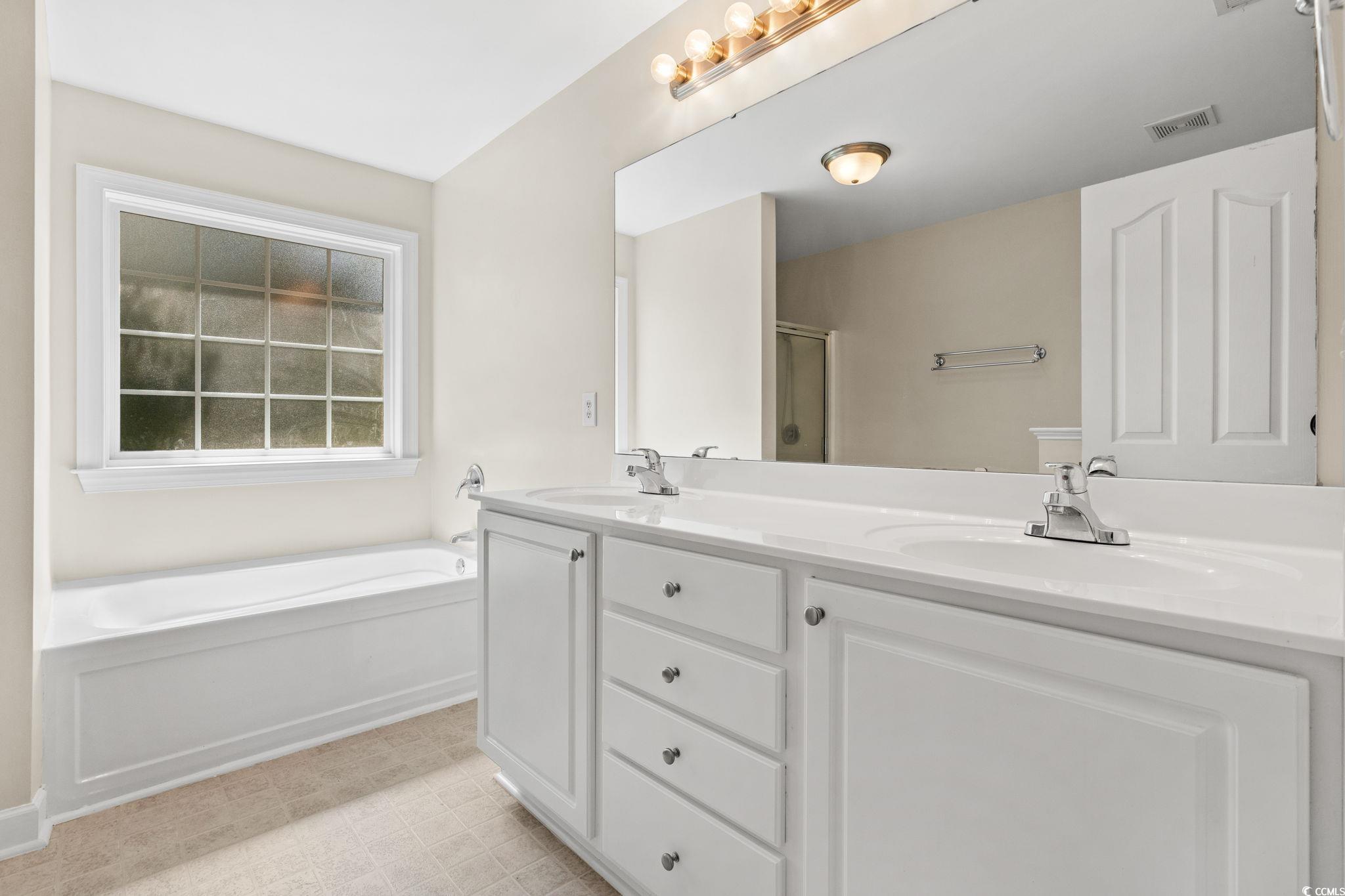181 Dunbarton Lane Conway, SC 29526 - Photo 23 of 40 Full bathroom featuring a stall shower, a garden tub, and double vanity