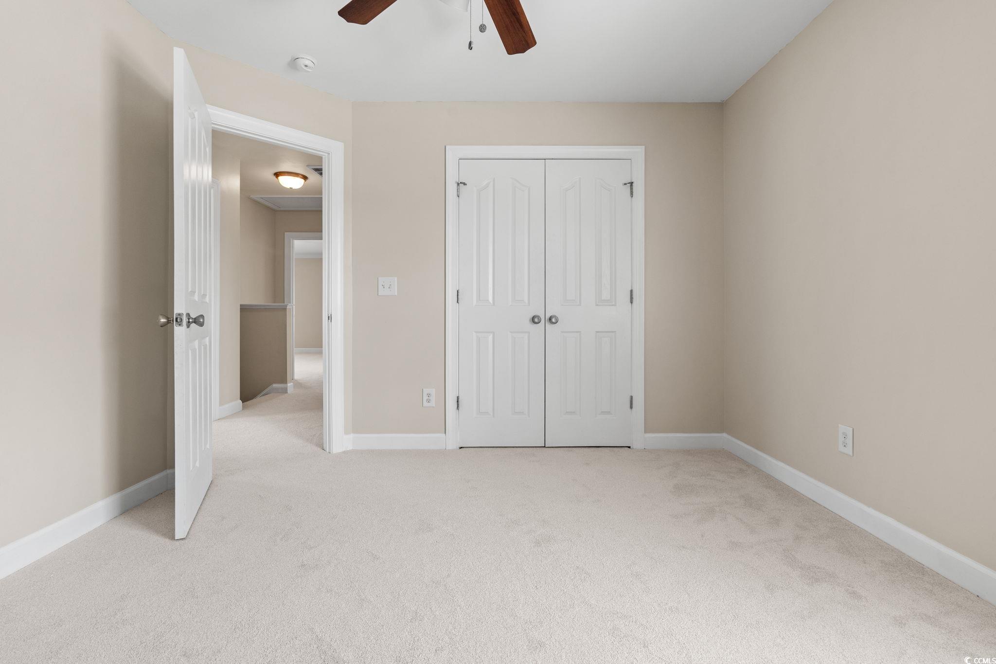 181 Dunbarton Lane Conway, SC 29526 - Photo 32 of 40 Unfurnished bedroom featuring light carpet, a closet, and a ceiling fan
