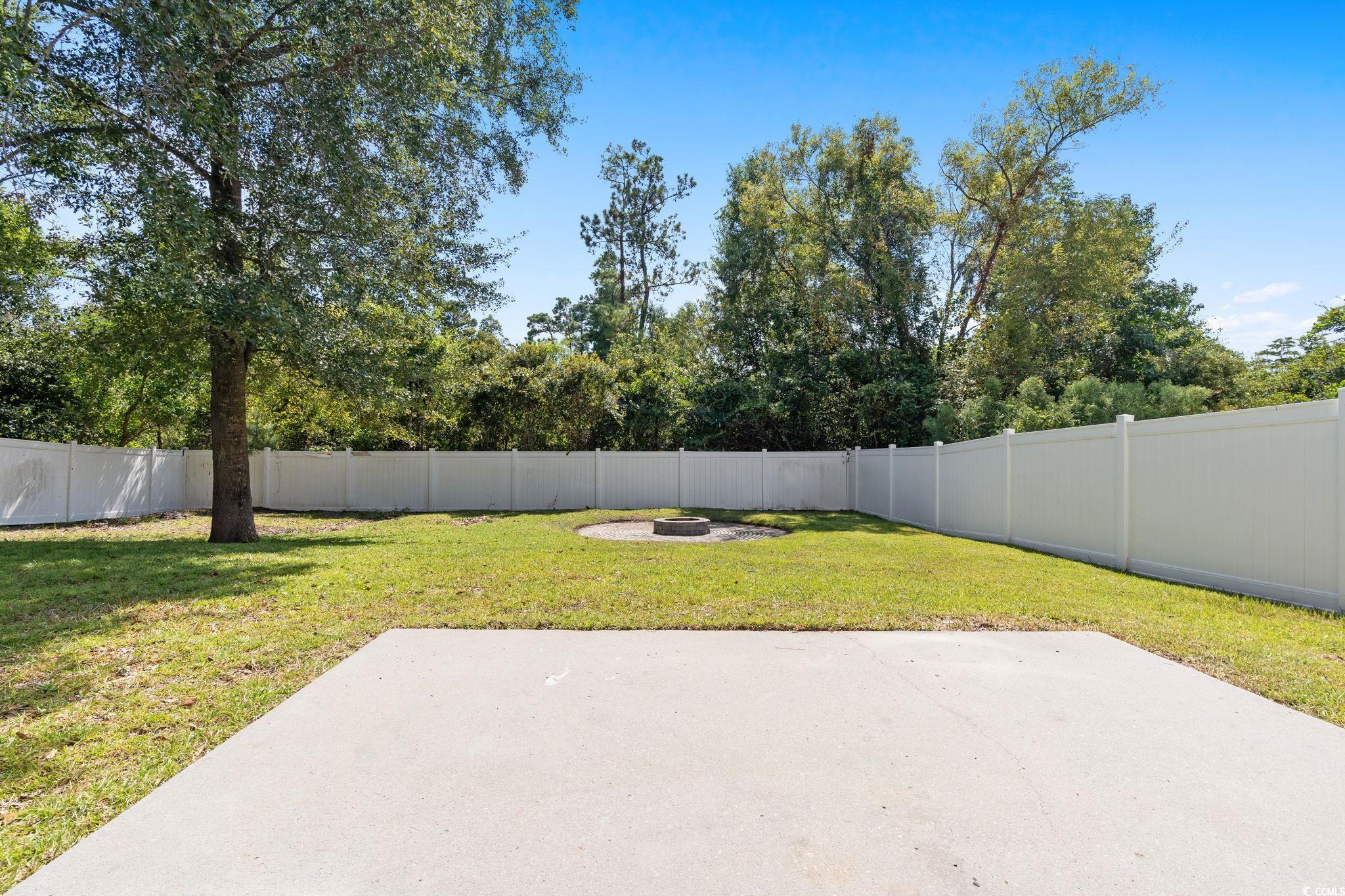 181 Dunbarton Lane Conway, SC 29526 - Photo 33 of 40 Fenced backyard with a patio area and a fire pit