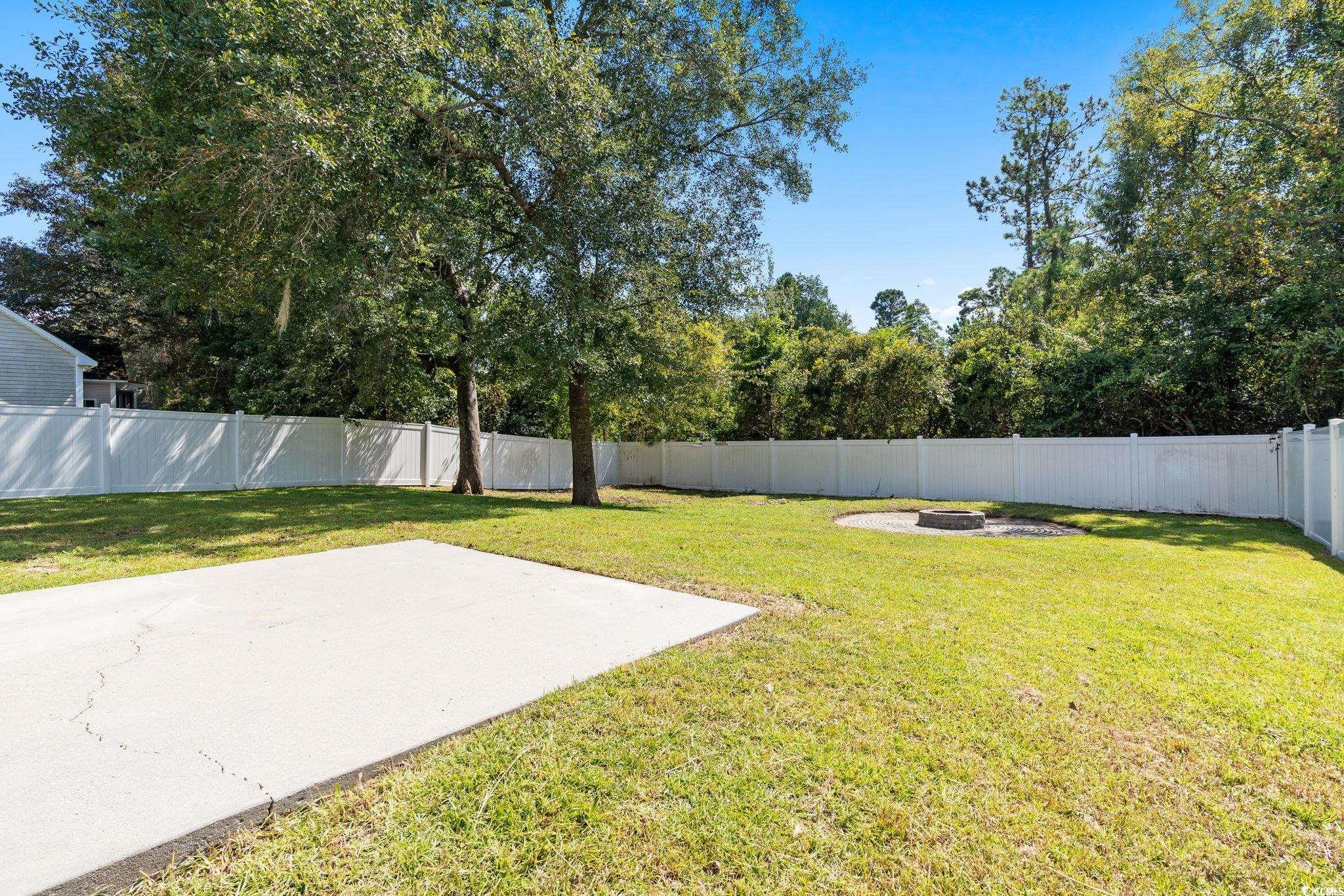 181 Dunbarton Lane Conway, SC 29526 - Photo 40 of 40 Fenced backyard with a patio and a fire pit