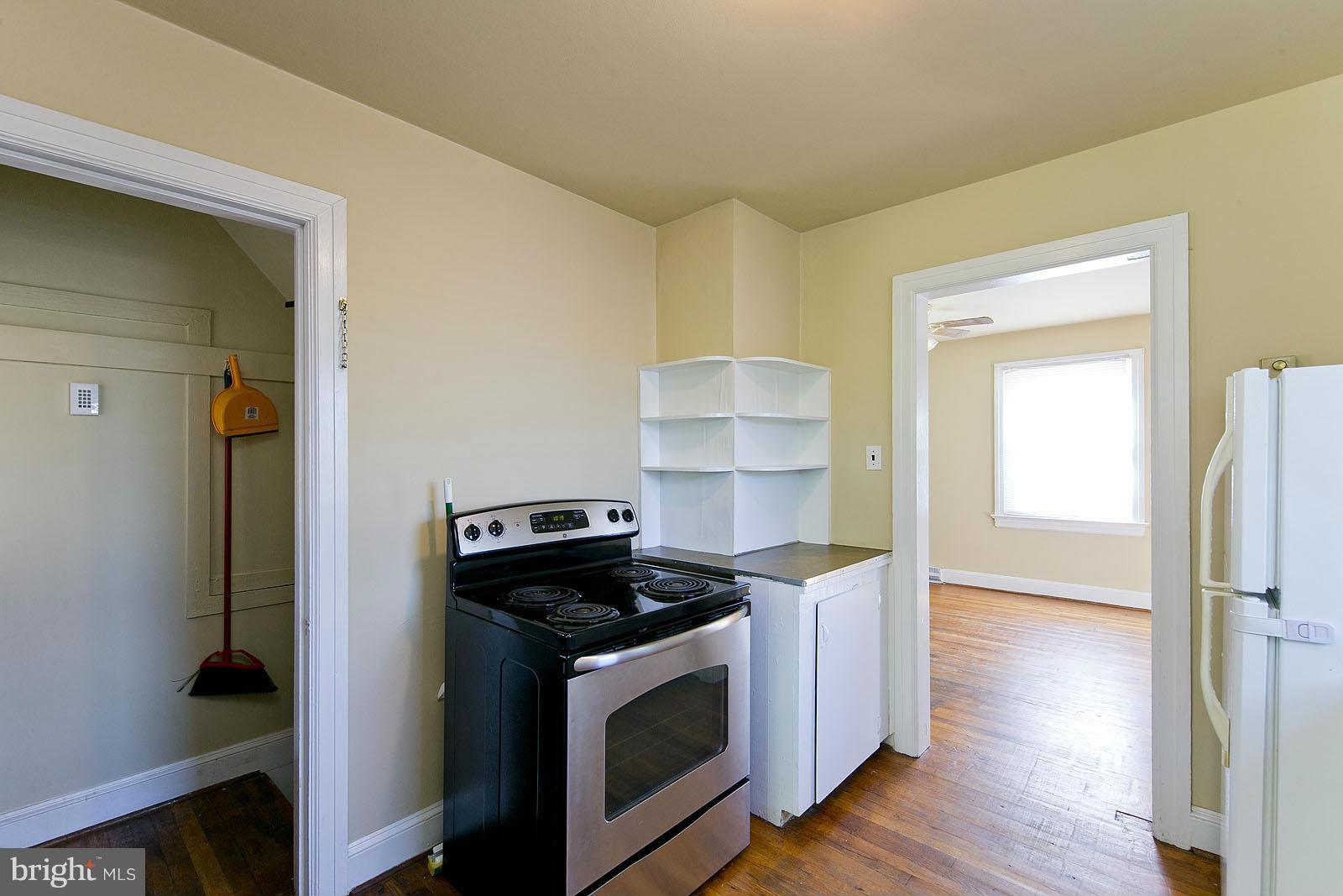 2244 Strasburg Road Front Royal, VA 22630 - Photo 14 of 30 a kitchen with a stove and a wooden floor