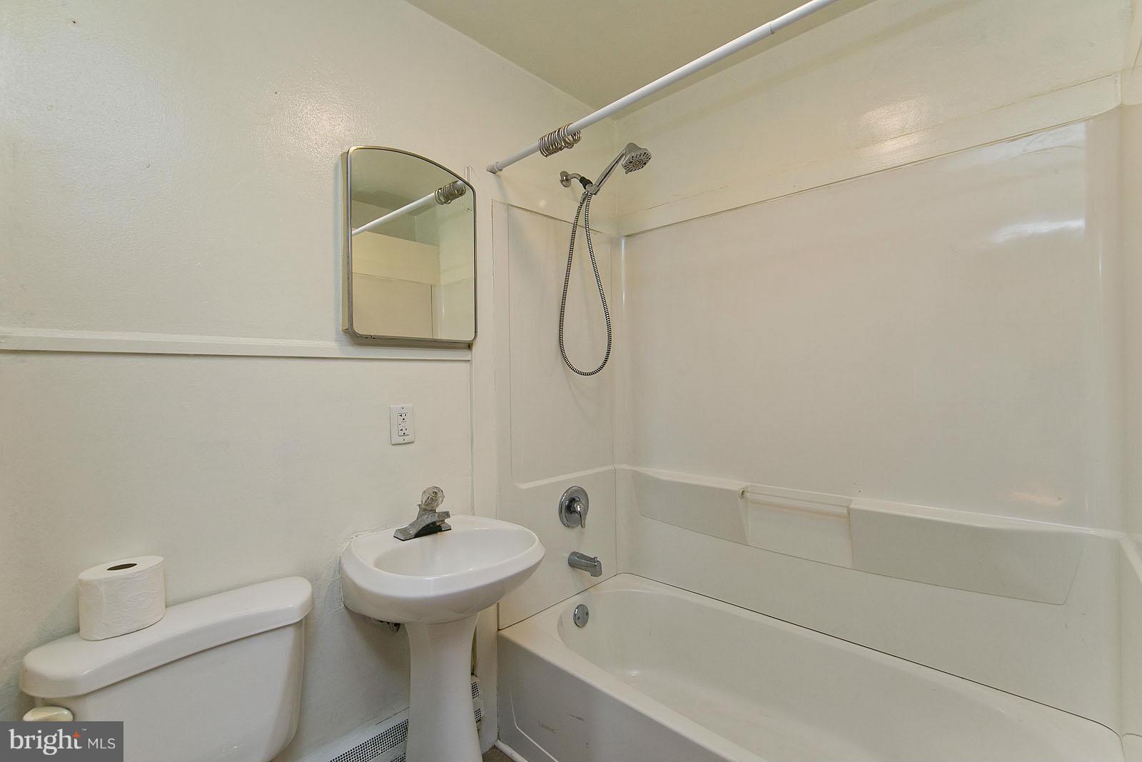 2244 Strasburg Road Front Royal, VA 22630 - Photo 20 of 30 a bathroom with a white bath tub a toilet and a sink