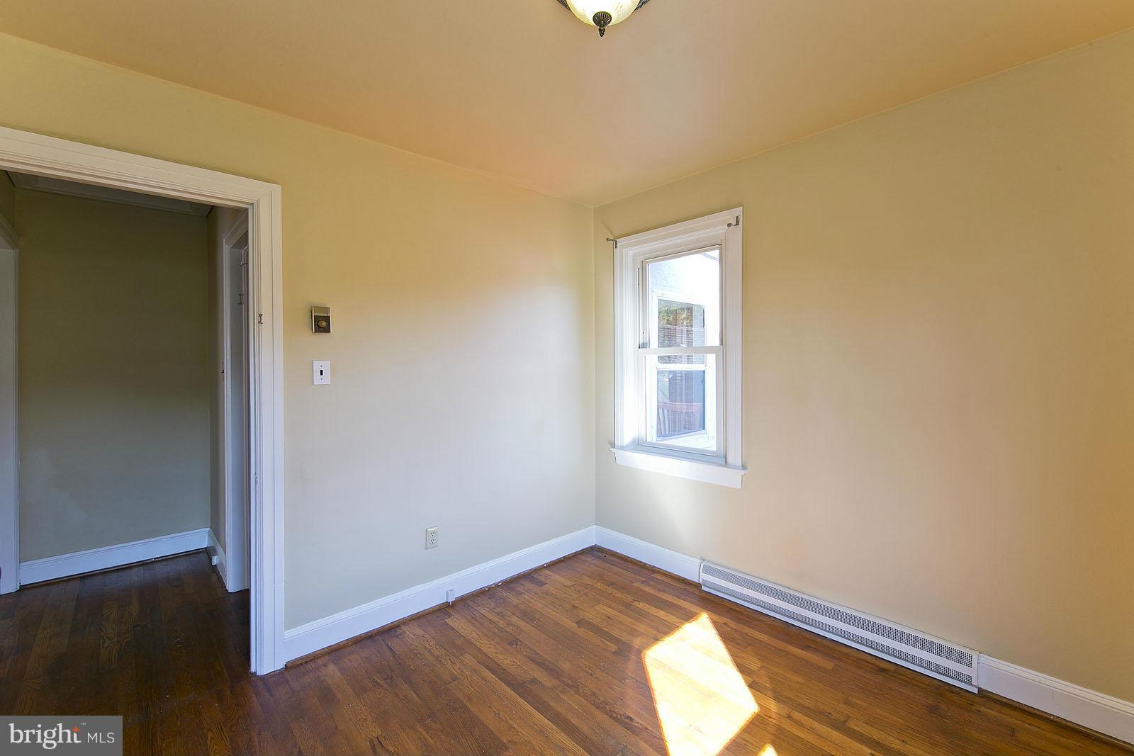 2244 Strasburg Road Front Royal, VA 22630 - Photo 23 of 30 an empty room with wooden floor and windows