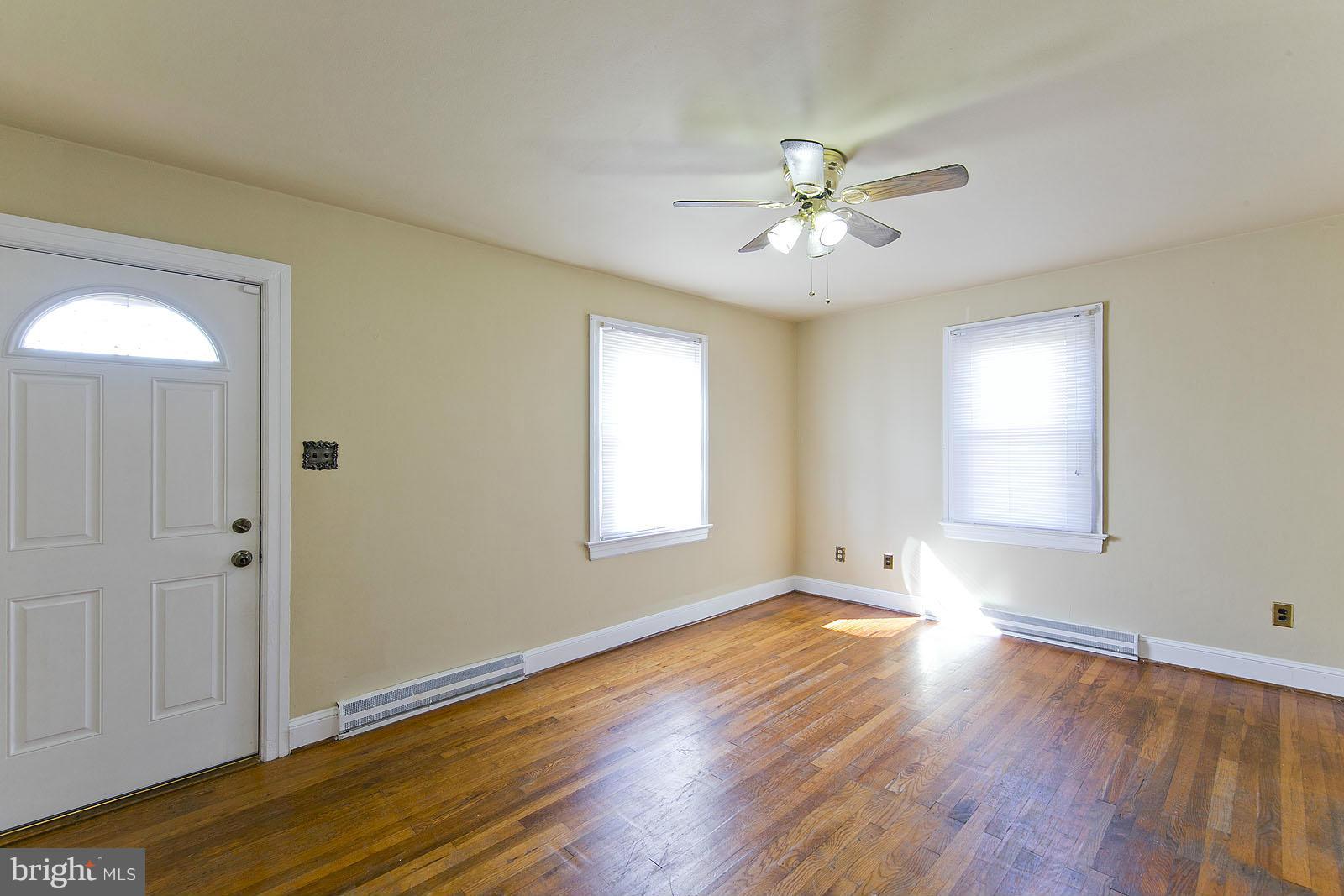 2244 Strasburg Road Front Royal, VA 22630 - Photo 5 of 30 a view of an empty room with wooden floor and a window