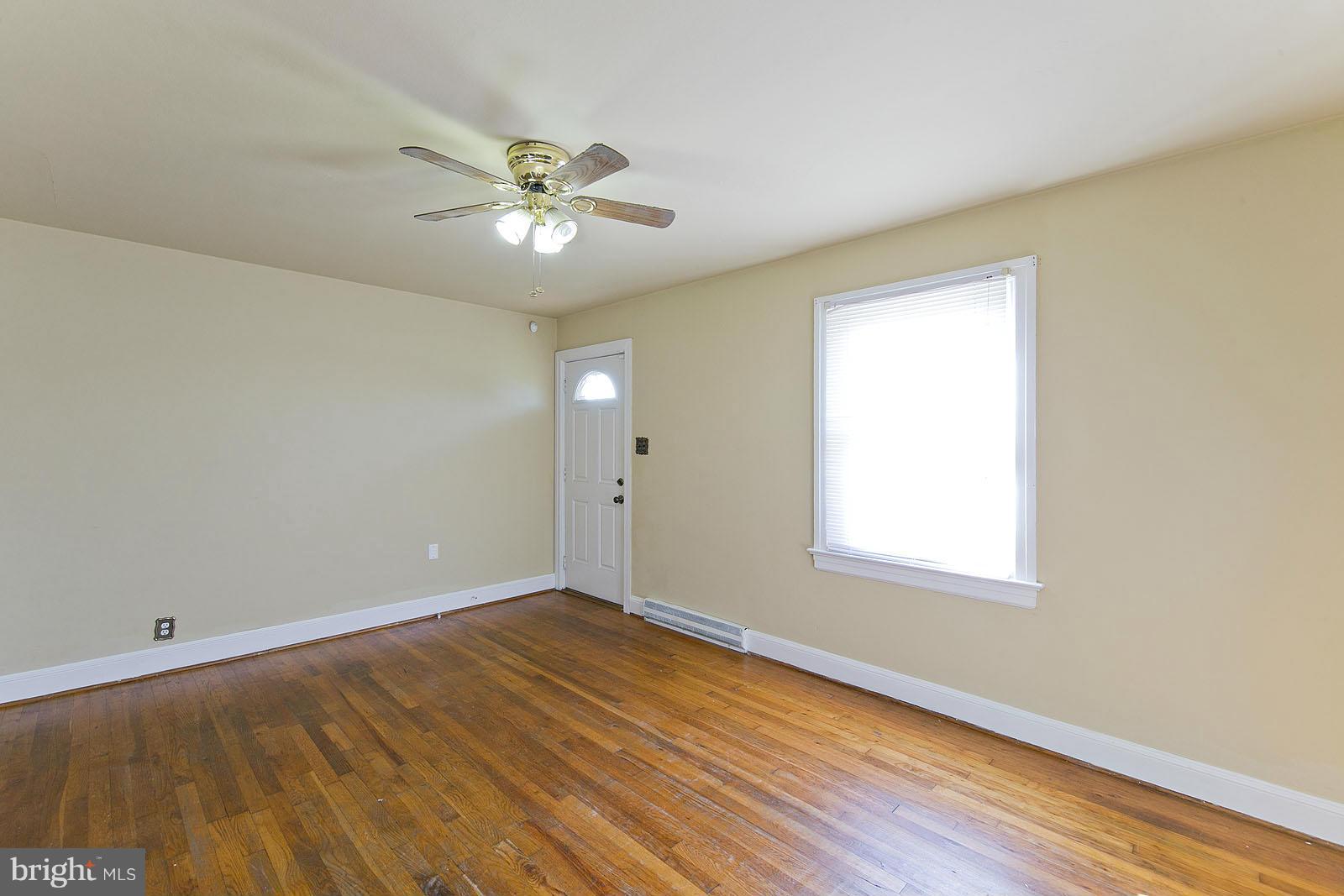 2244 Strasburg Road Front Royal, VA 22630 - Photo 7 of 30 a view of an empty room with wooden floor and a window