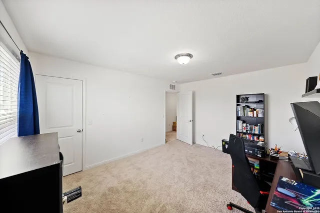 a view of a workspace with furniture and window