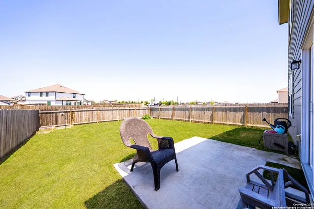 a swimming pool with outdoor seating and yard