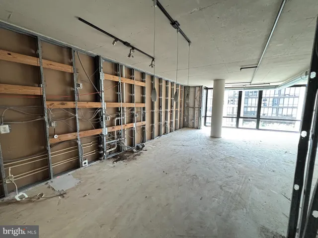 a view of empty room with floor to ceiling window and entryway