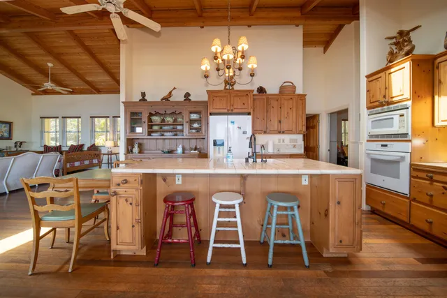 a kitchen with stainless steel appliances granite countertop a stove and a wooden floors