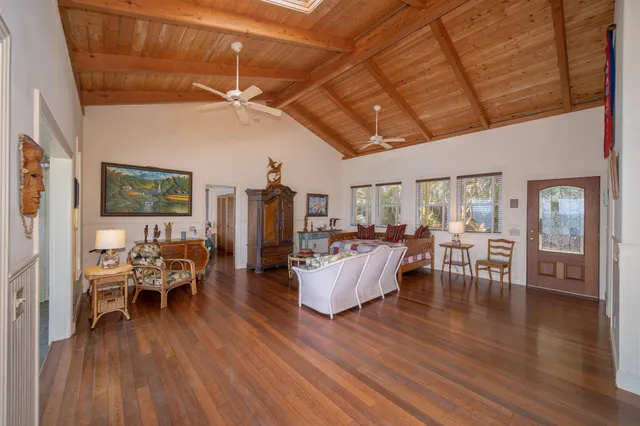 a bedroom with a bed a window and chair