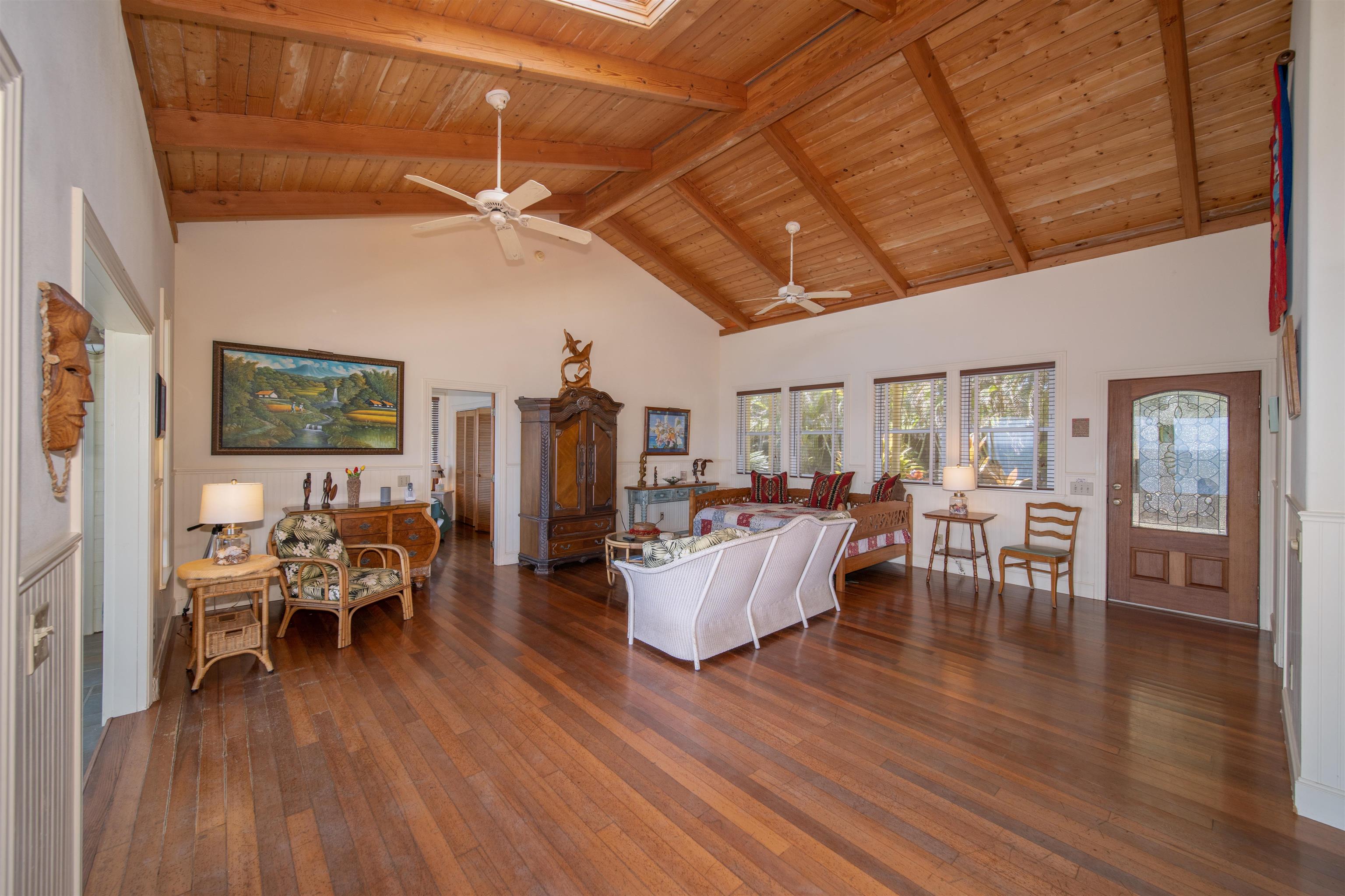 4955 Uakea Road Hana, HI 96713 - Photo 15 of 36 a living room with lots of furniture and hard wood flooring