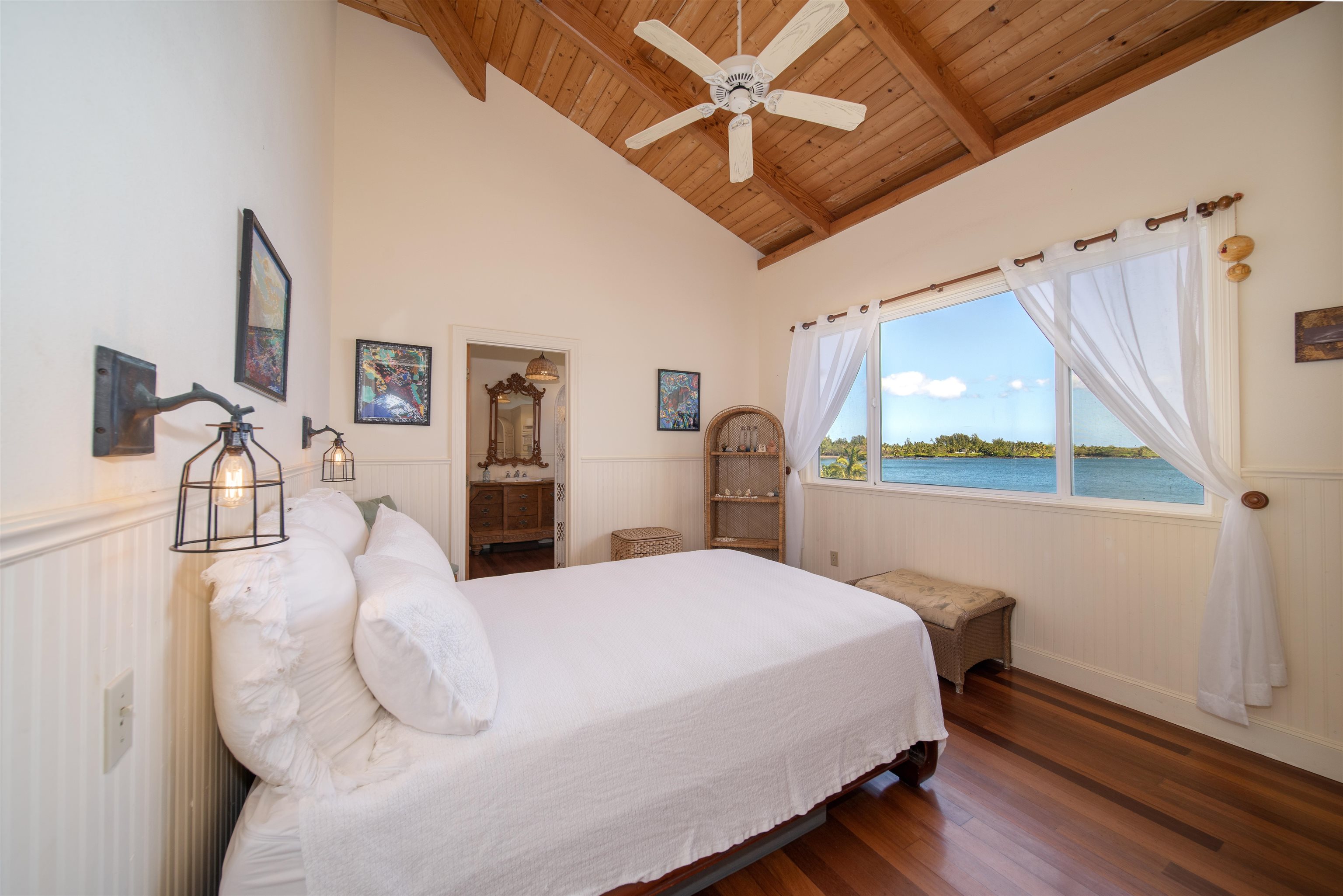 4955 Uakea Road Hana, HI 96713 - Photo 21 of 36 a bedroom with a bed mirror and window