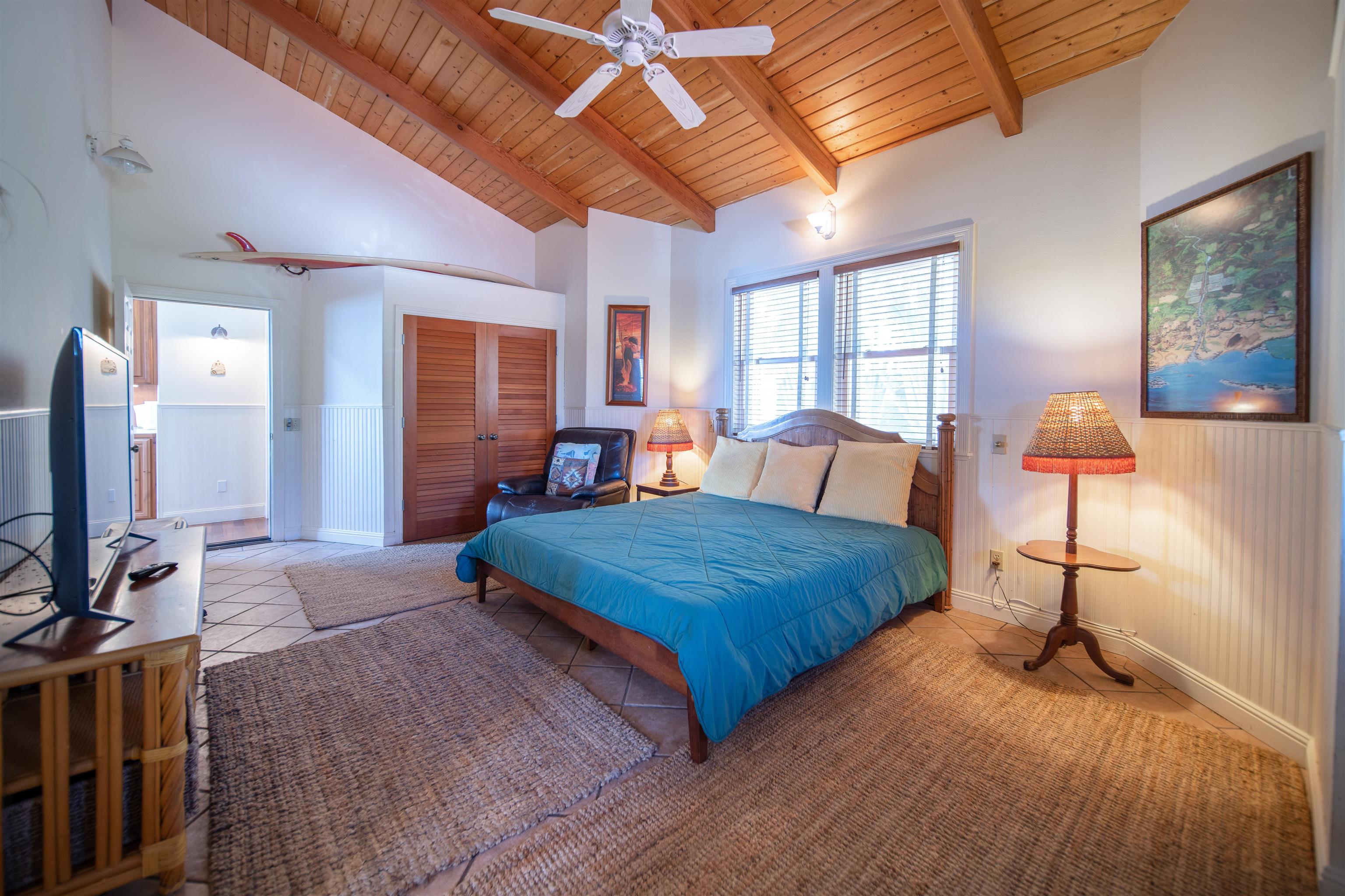 4955 Uakea Road Hana, HI 96713 - Photo 25 of 36 a bedroom with a bed and wooden floor