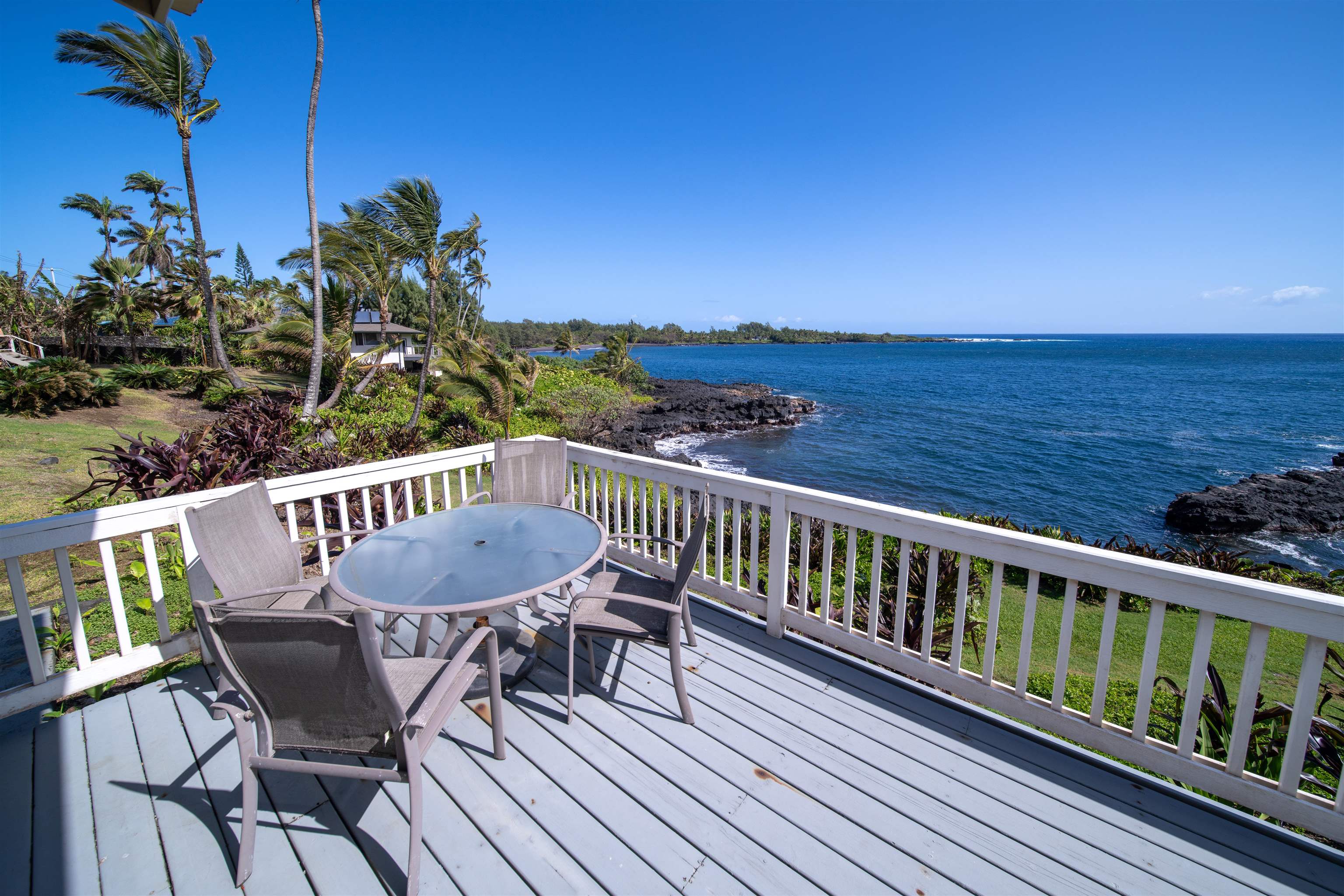 4955 Uakea Road Hana, HI 96713 - Photo 33 of 36 a view of a chairs and table on the wooden deck