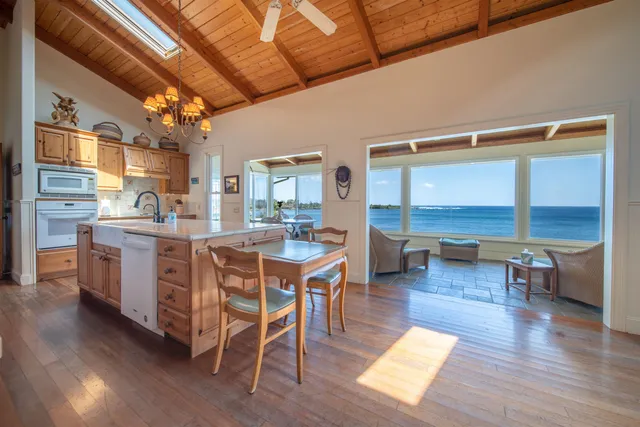 a kitchen with a table chairs and wooden floor