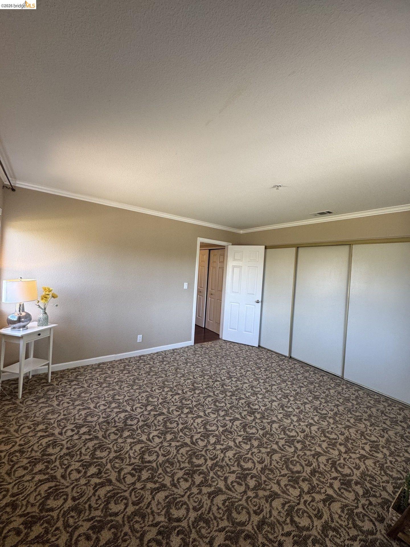 3623 Wells Road Oakley, CA 94561 - Photo 35 of 75 Wall-to-wall upgraded patterned carpeting, neutral wall finishes, crown molding, and extra large closet with 3 panel sliding closet doors