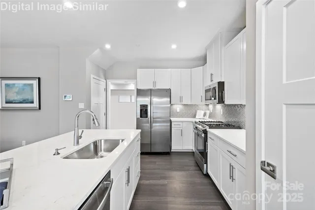 a kitchen with white cabinets and white appliances