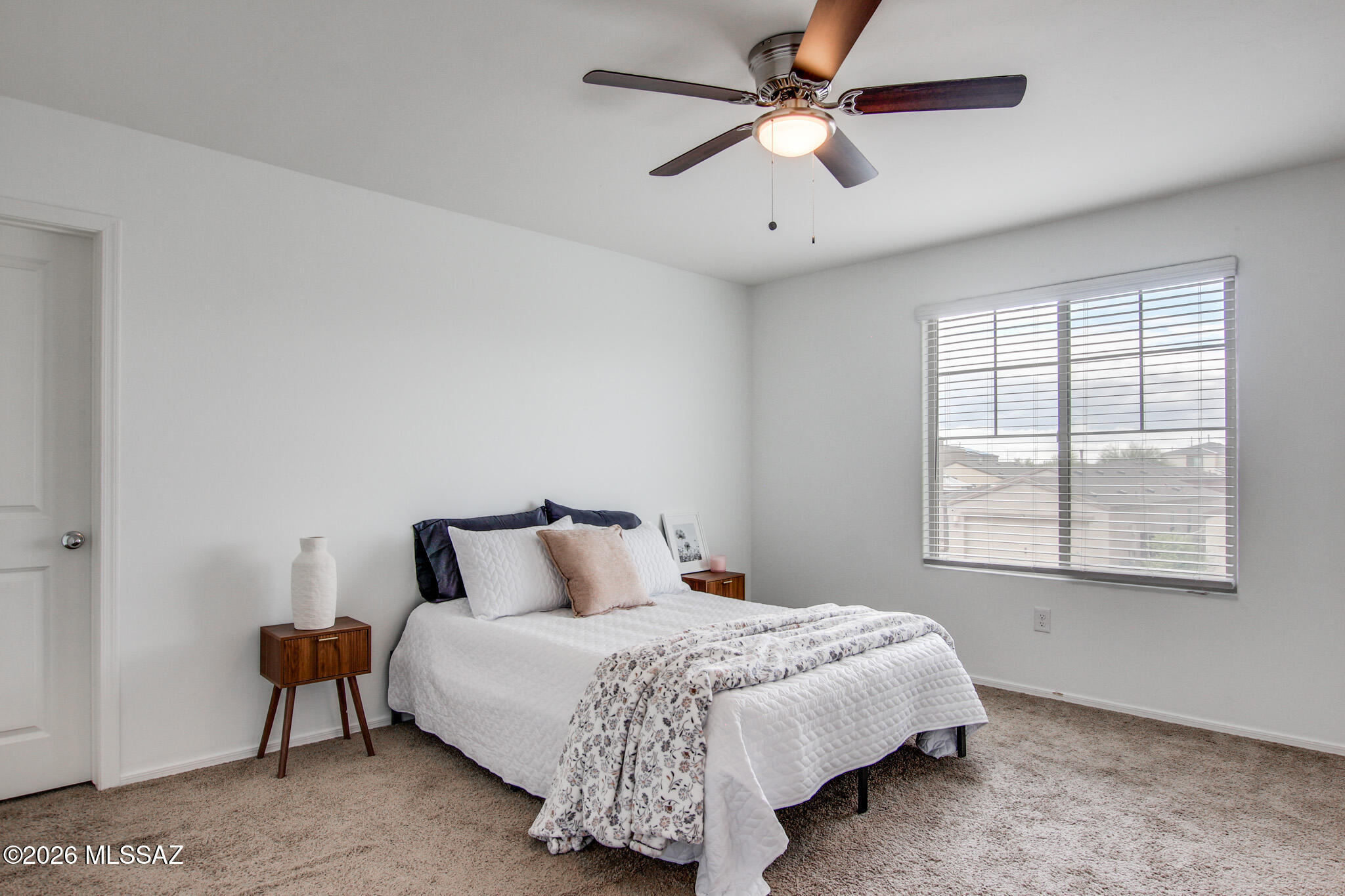 5987 South Antrim Loop Tucson, AZ 85706 - Photo 20 of 34 a bedroom with a large bed and a ceiling fan