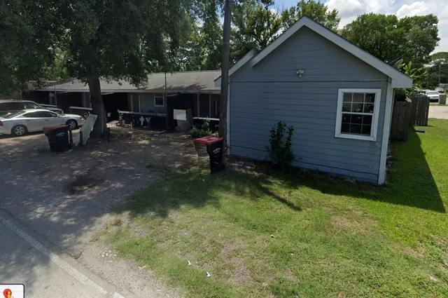 a view of backyard of house with outdoor seating and green space