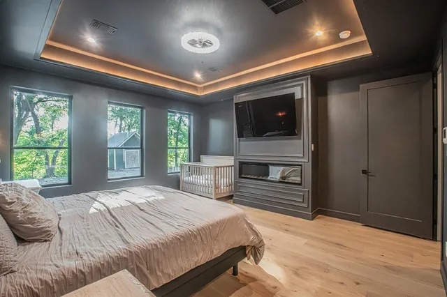 a bedroom with a bed and a flat screen tv