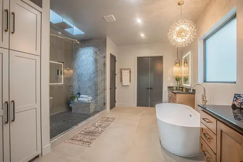 a spacious bathroom with a granite countertop sink a toilet shower and a mirror