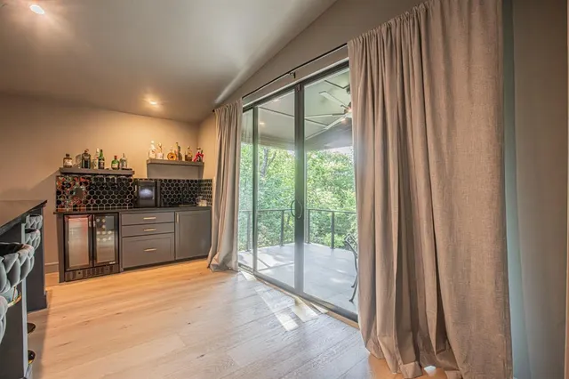 a kitchen with stainless steel appliances granite countertop a stove a sink and a refrigerator with wooden floor