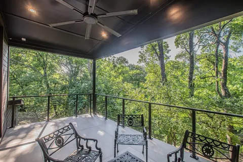 a view of a balcony with furniture and wooden floor