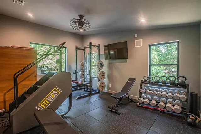 a living room with furniture a flat screen tv and a large window
