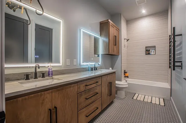 a bathroom with a sink toilet and shower