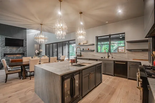 a kitchen with a stove a sink a dining table and chairs