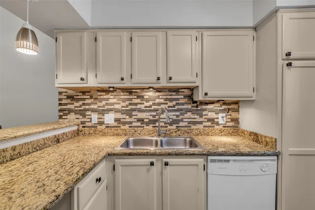 a kitchen with a sink and cabinets