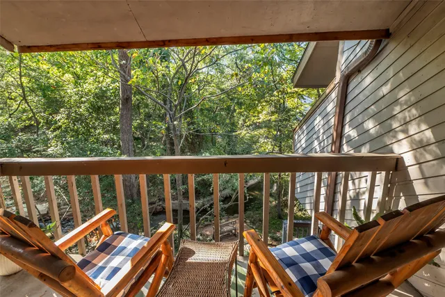 a view of a two chairs in the balcony