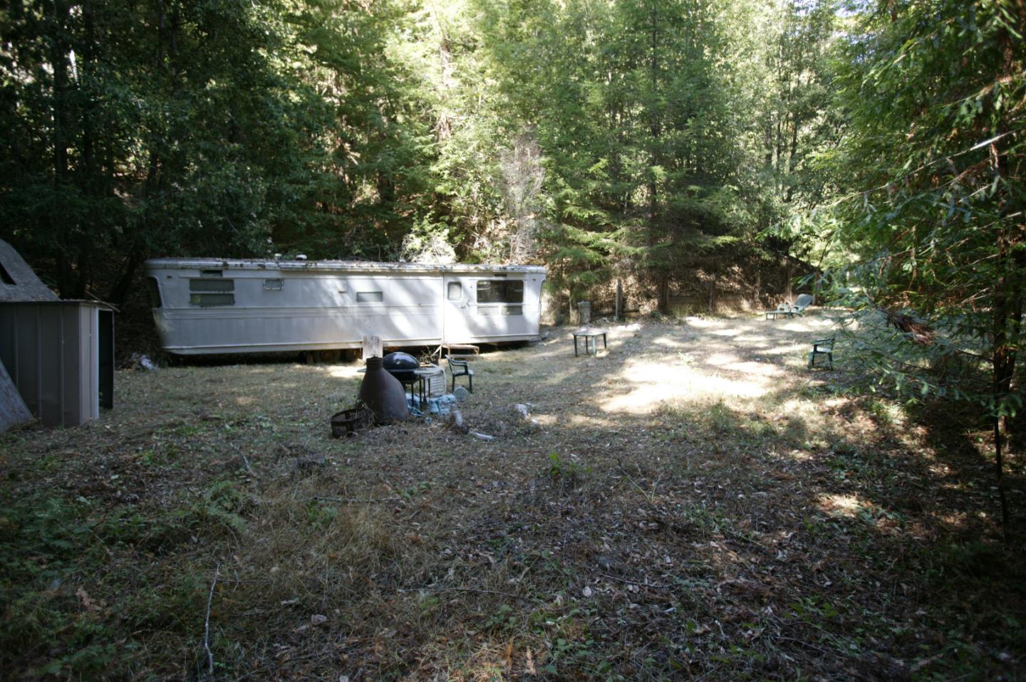 a view of a chairs and table in the backyard