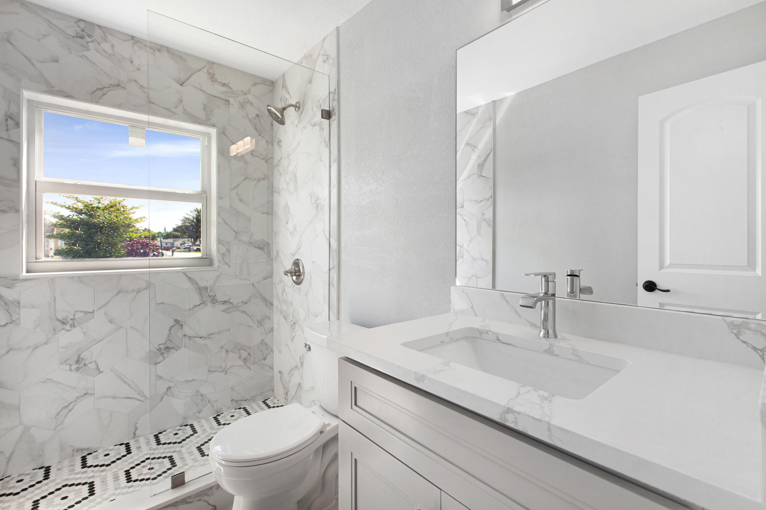 22848 Southwest 54th Way Boca Raton, FL 33433 - Photo 15 of 20 a bathroom with a sink toilet a mirror and shower