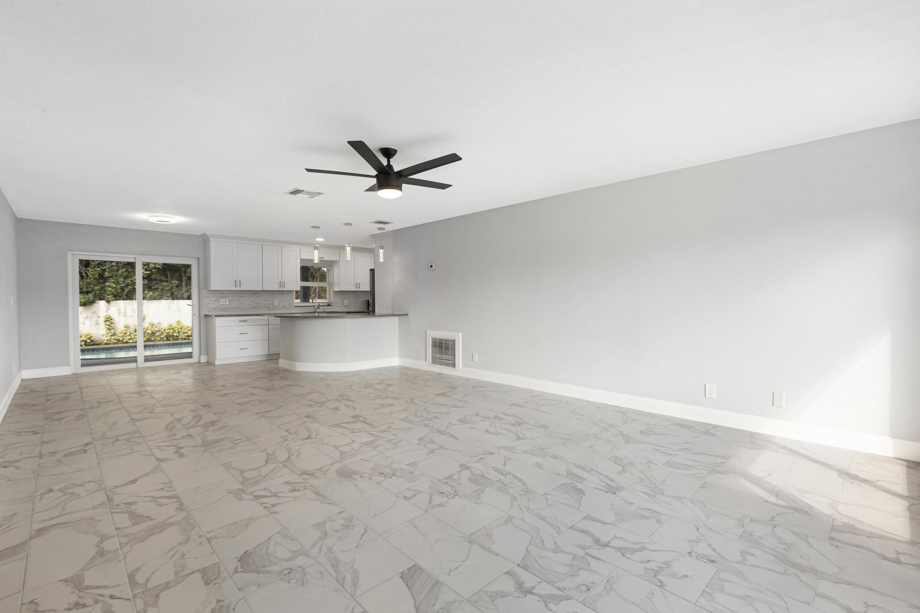 22848 Southwest 54th Way Boca Raton, FL 33433 - Photo 2 of 20 a view of a kitchen with a sink and a stove top oven