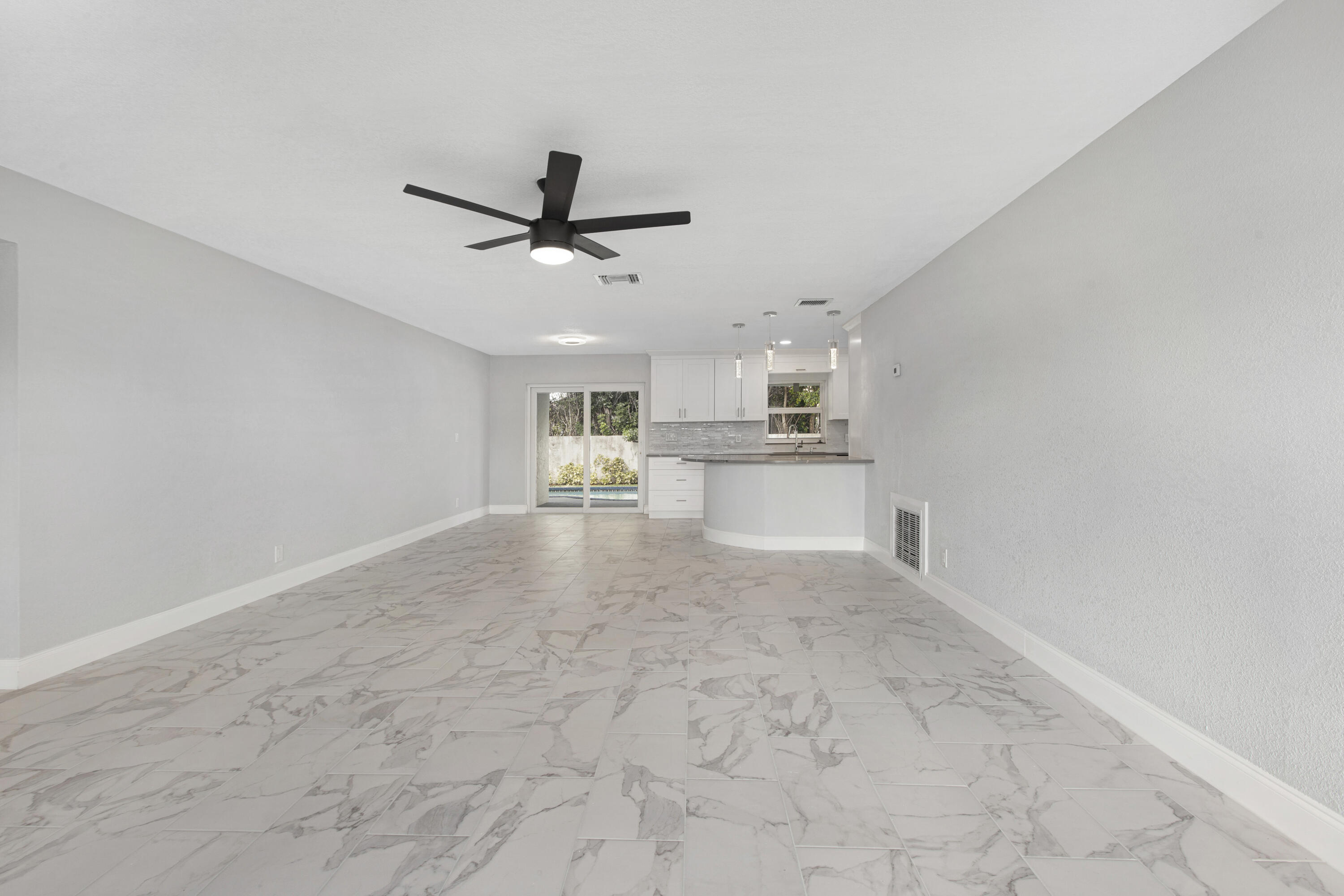 22848 Southwest 54th Way Boca Raton, FL 33433 - Photo 3 of 20 a view of a kitchen with a sink and a stove top oven