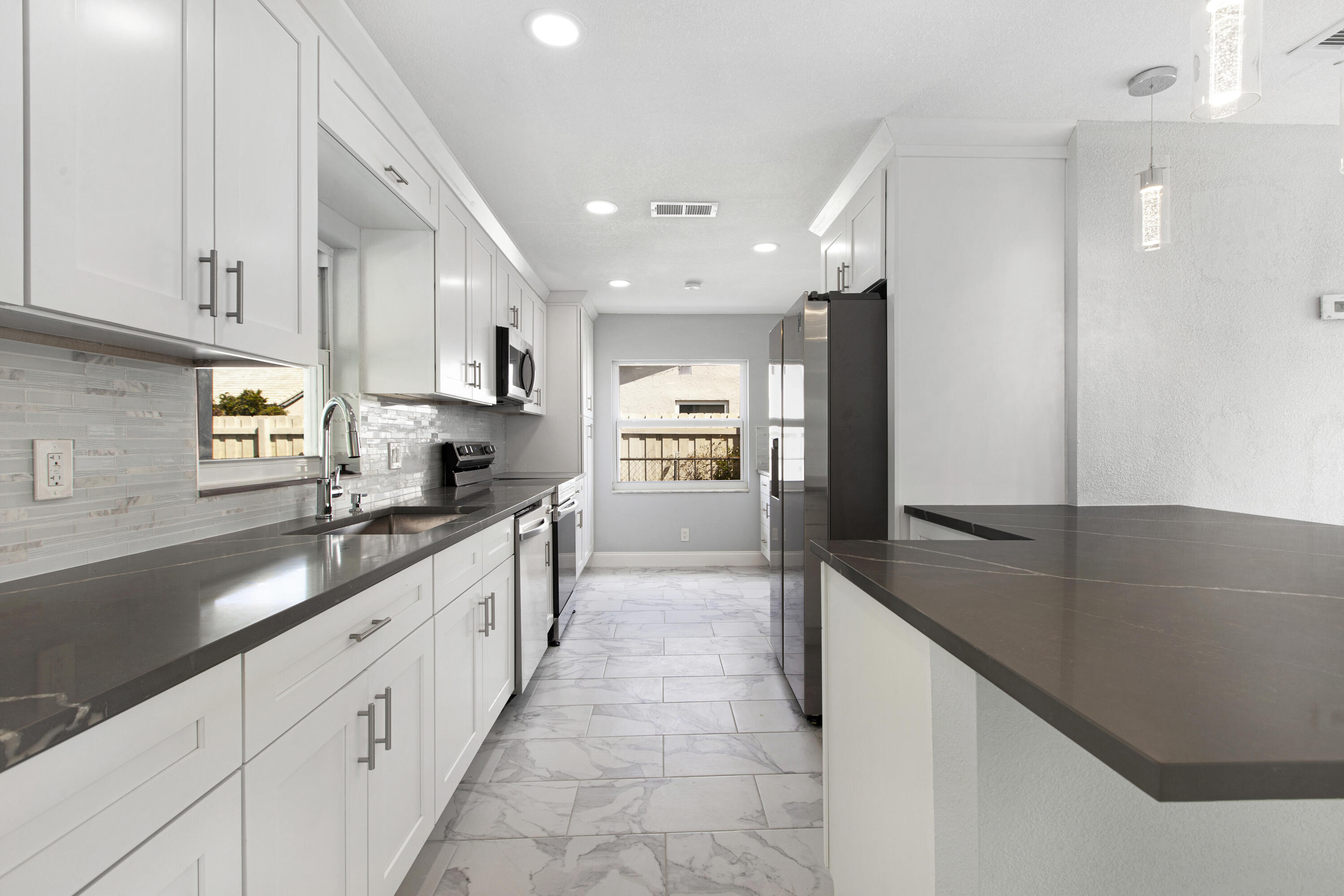 22848 Southwest 54th Way Boca Raton, FL 33433 - Photo 7 of 20 a large kitchen with stainless steel appliances lots of counter top space