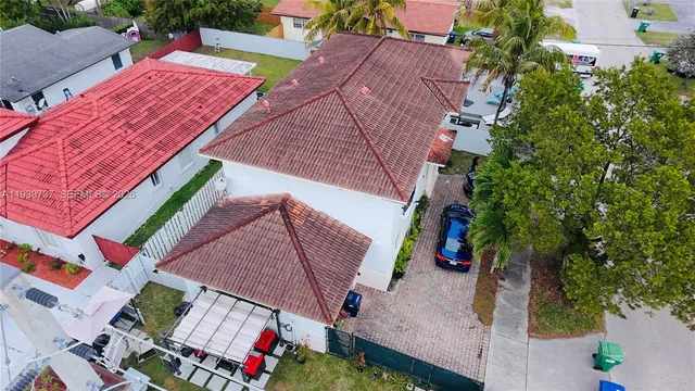 an aerial view of a house with a yard