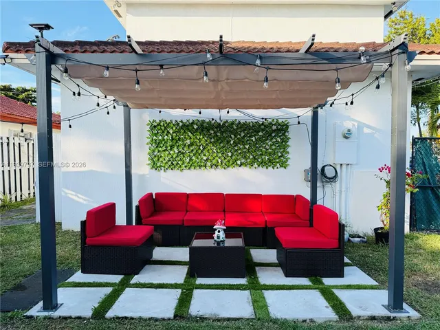 a view of a balcony with chairs and wooden floor