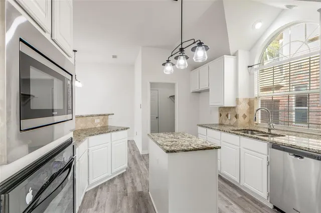 a kitchen with a sink stove and cabinets